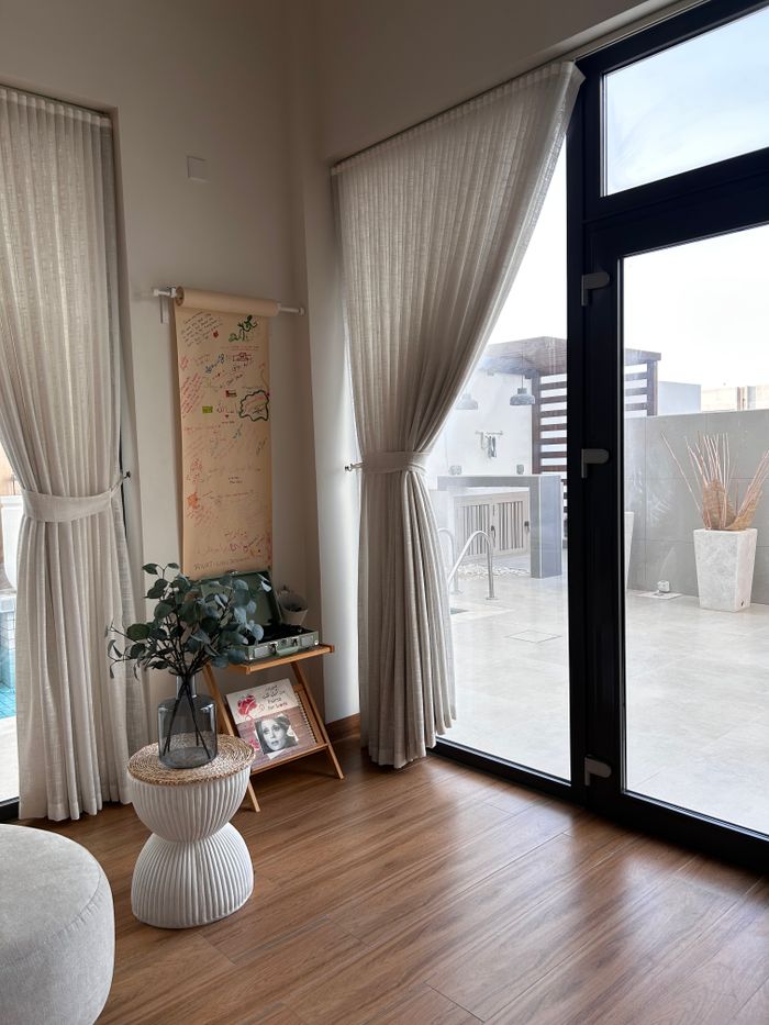 Bright modern living room featuring elegant decor and a clear view of the patio.