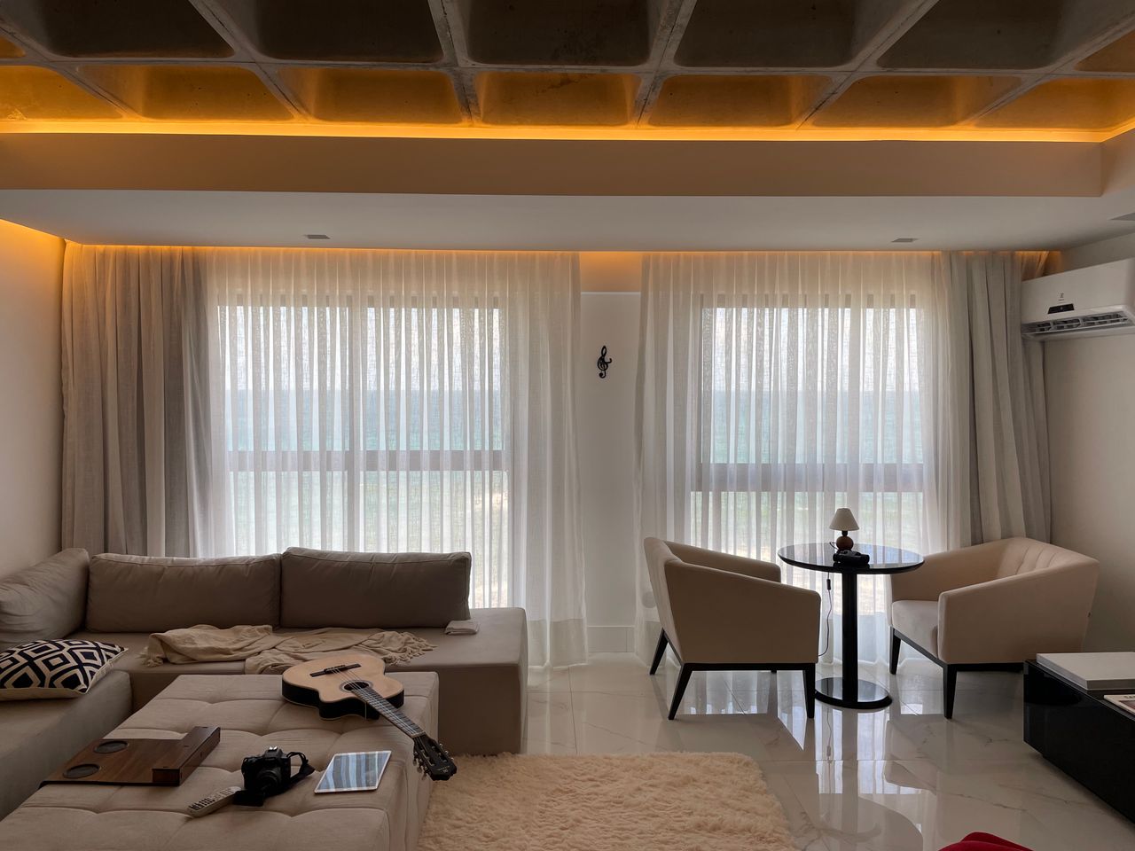 digital Contemporary living room with a cozy and elegant design featuring soft lighting, a couch, and a coffee table.